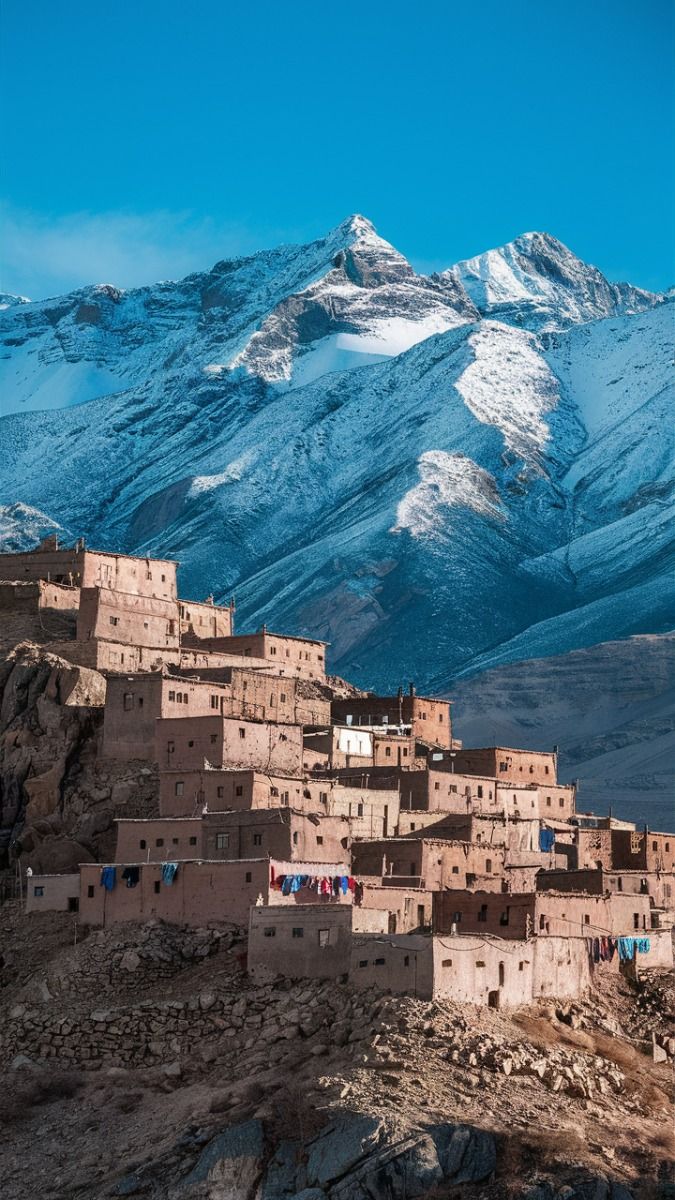 Snow-capped Atlas Mountains in Morocco with green valleys below